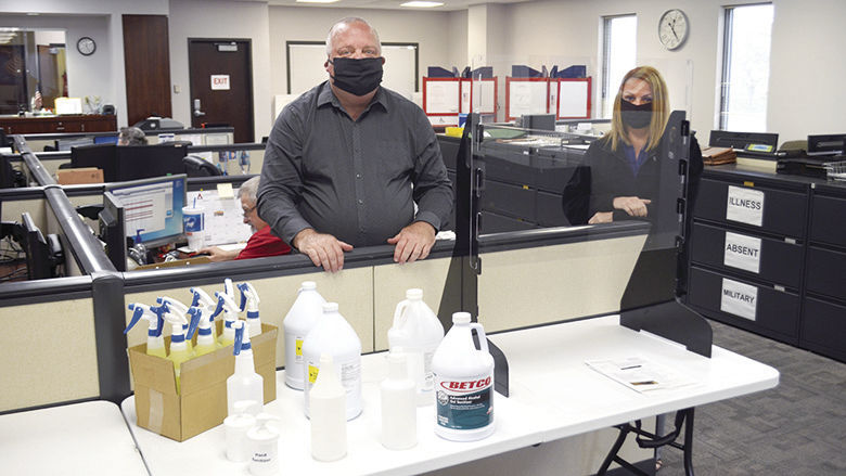 Jefferson County Clerk Ken Waller and Chief of Staff Jeannie Goff display a small assortment of protective equipment that will be in polling places for the June 2 election.